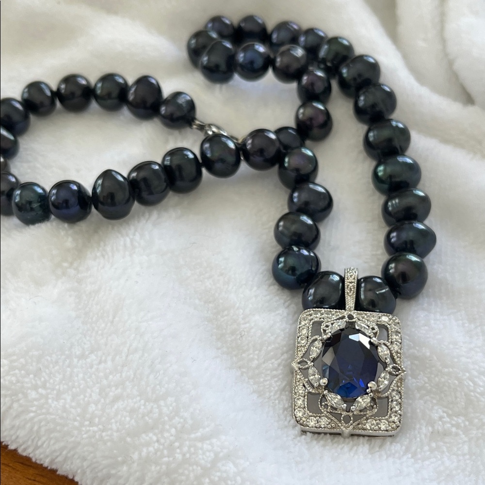 Luxurious navy pearls and detachable   Silver with blue stone enhancer pendant.